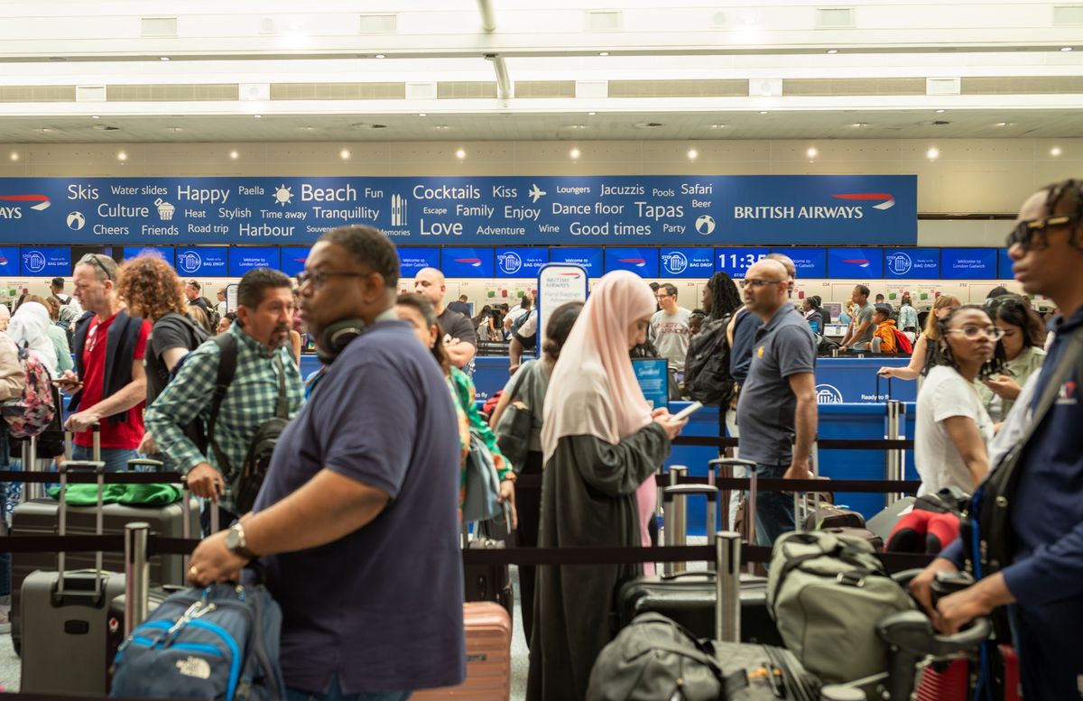 People queue to check in for flights at Gatwick Airport