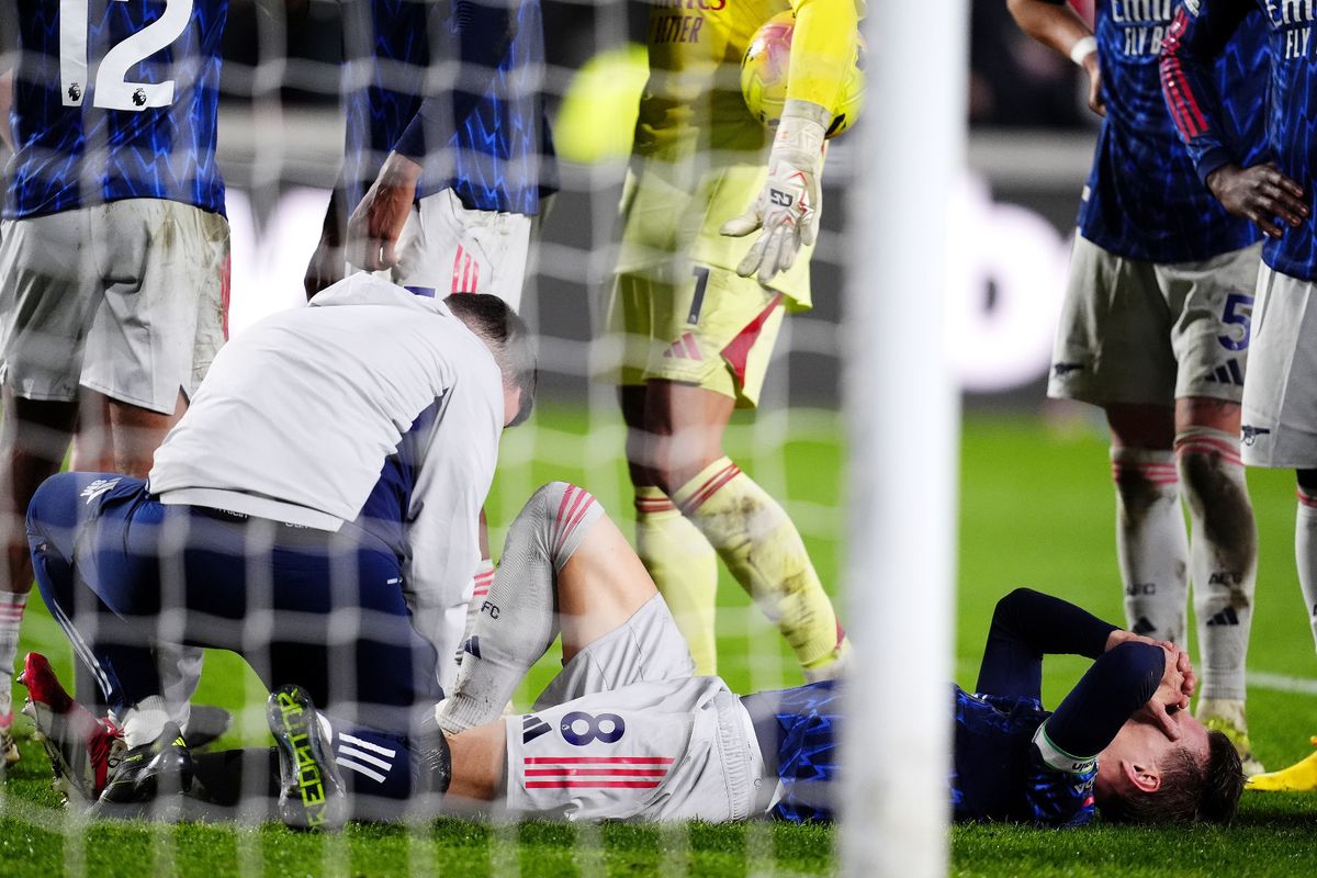 Martin Odegaard receives treatment from Arsenal physios