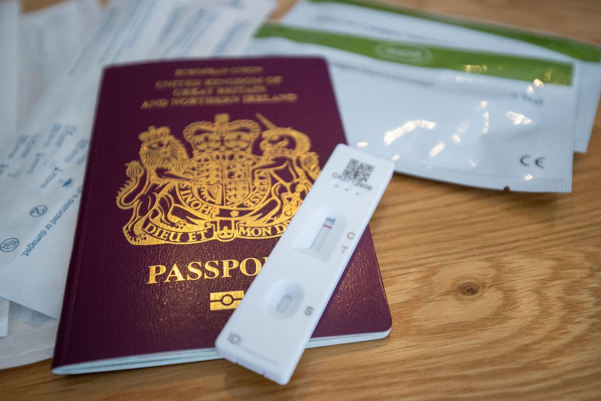 A negative Covid-19 test sits on top of a Passport for the United Kingdom of Great Britain and Northern Ireland. 