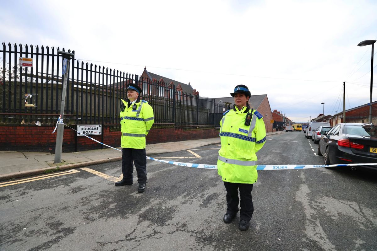 Police stand guard at the cordon on Douglas Road, Anfield
