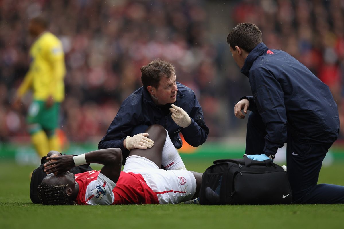Bacary Sagna receiving treatment for a broken leg against Norwich in May 2012