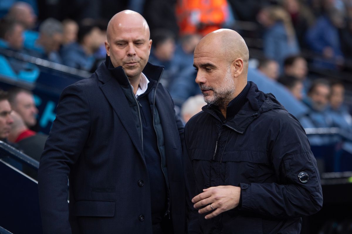 Manchester City head coach Pep Guardiola and Liverpool boss Arne Slot greet each other at the Etihad Stadium
