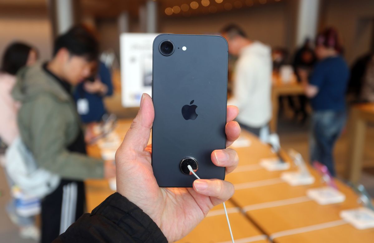 Person holding iPhone 16e