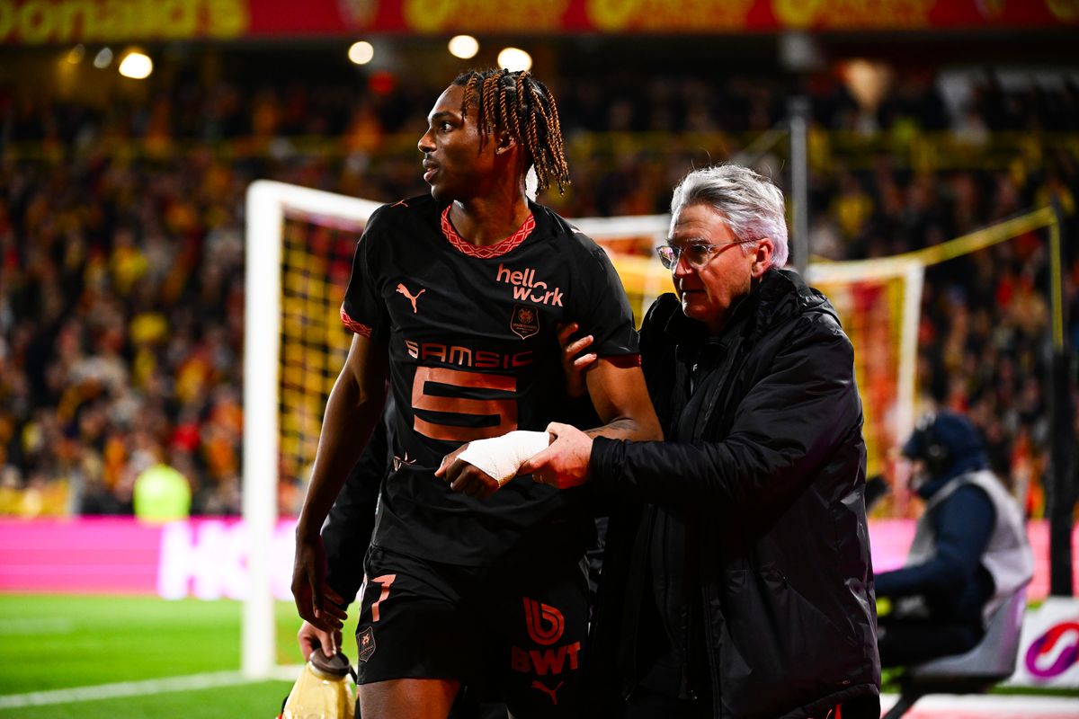 Jeremy Jacquet is helped by a member of Rennes staff