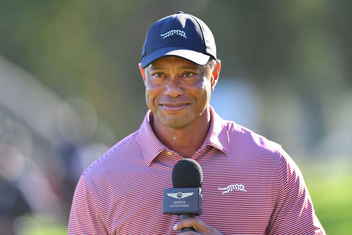 Tiger Woods holds a microphone