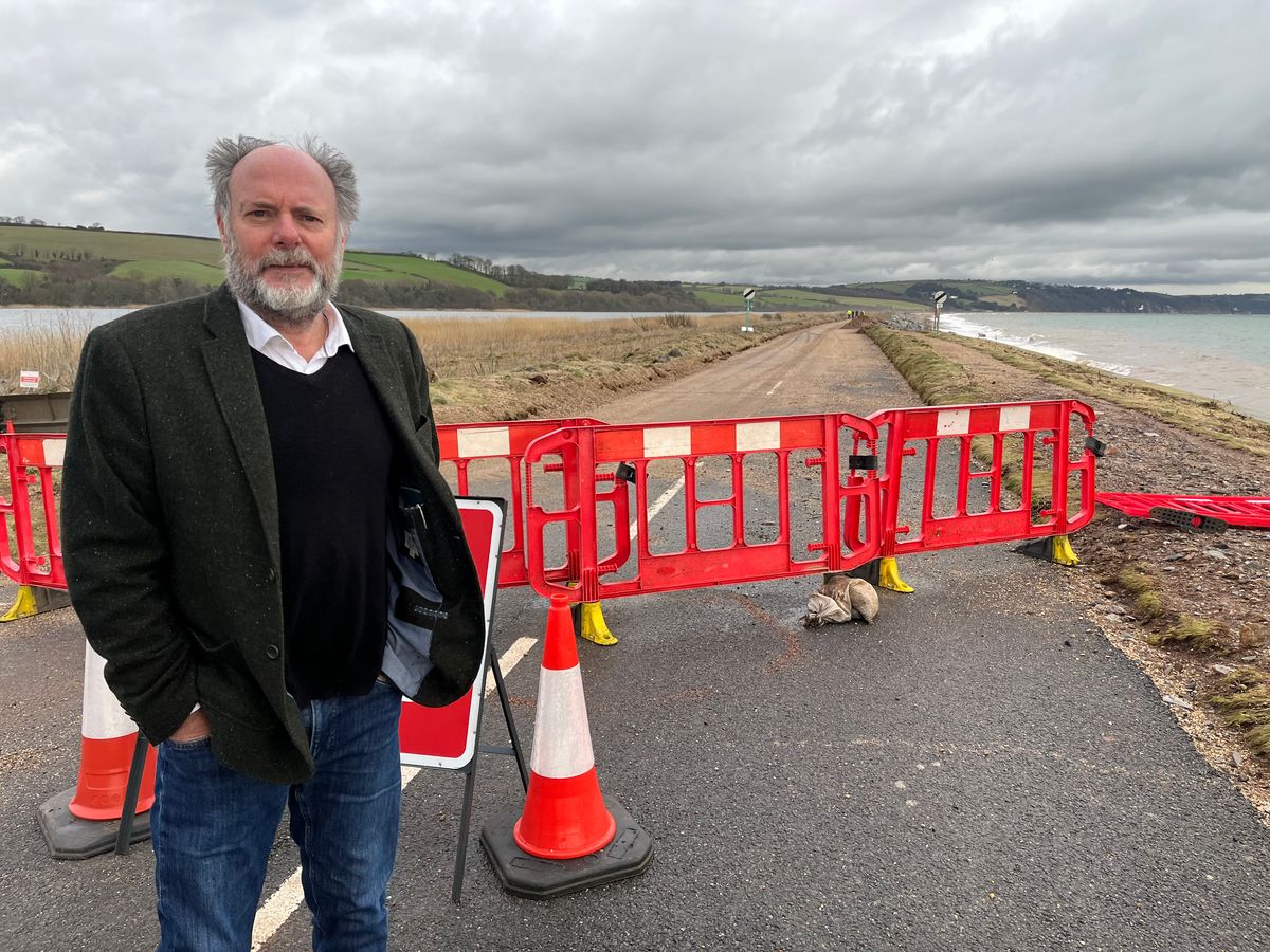 Councillor Julian Brazil, the leader of Devon County Council, assesses the damage to Torcross and the A379 road