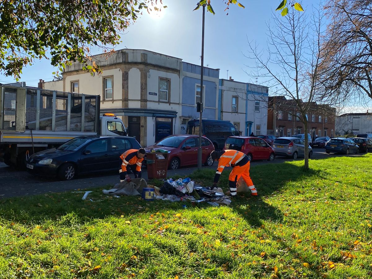 Bristol Waste workers clear a pile of illegally dumped rubbish in St Jude