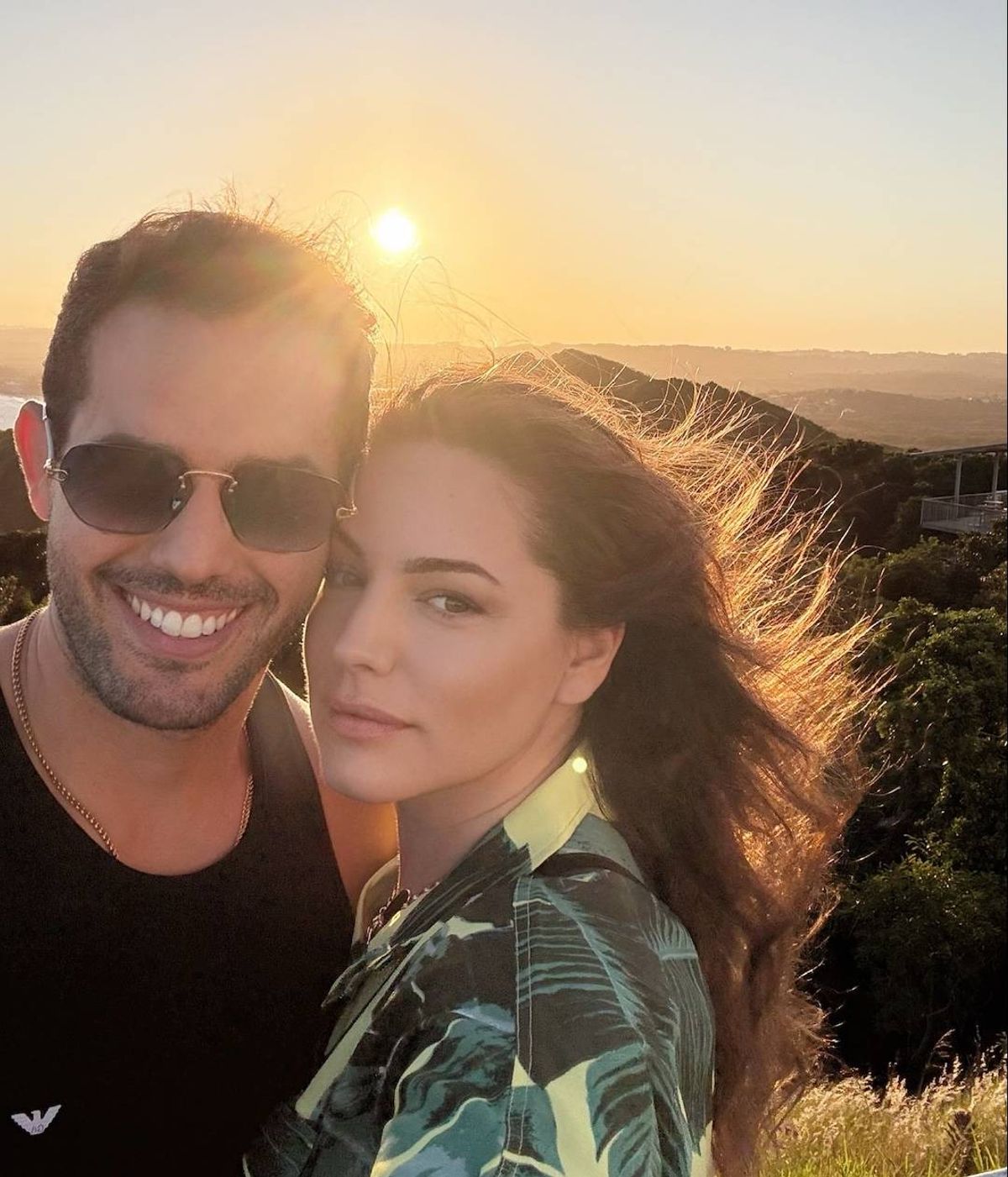 Jeremy Parisi and Kelly Brook posing with the sun setting behind them