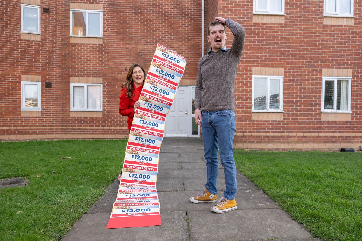 George presented with prize by lottery’s Judie McCourt
