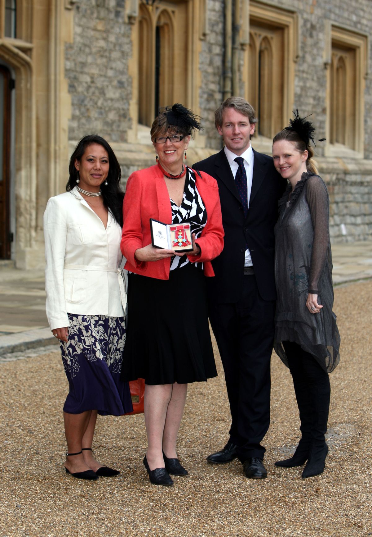 Cook, writer and broadcaster Prue Leith (2nd-L), with daughter Li-Da Kruger (L), her son Danny Kruger and his wife Emma pose after she became a Commander of the British Empire (CBE)