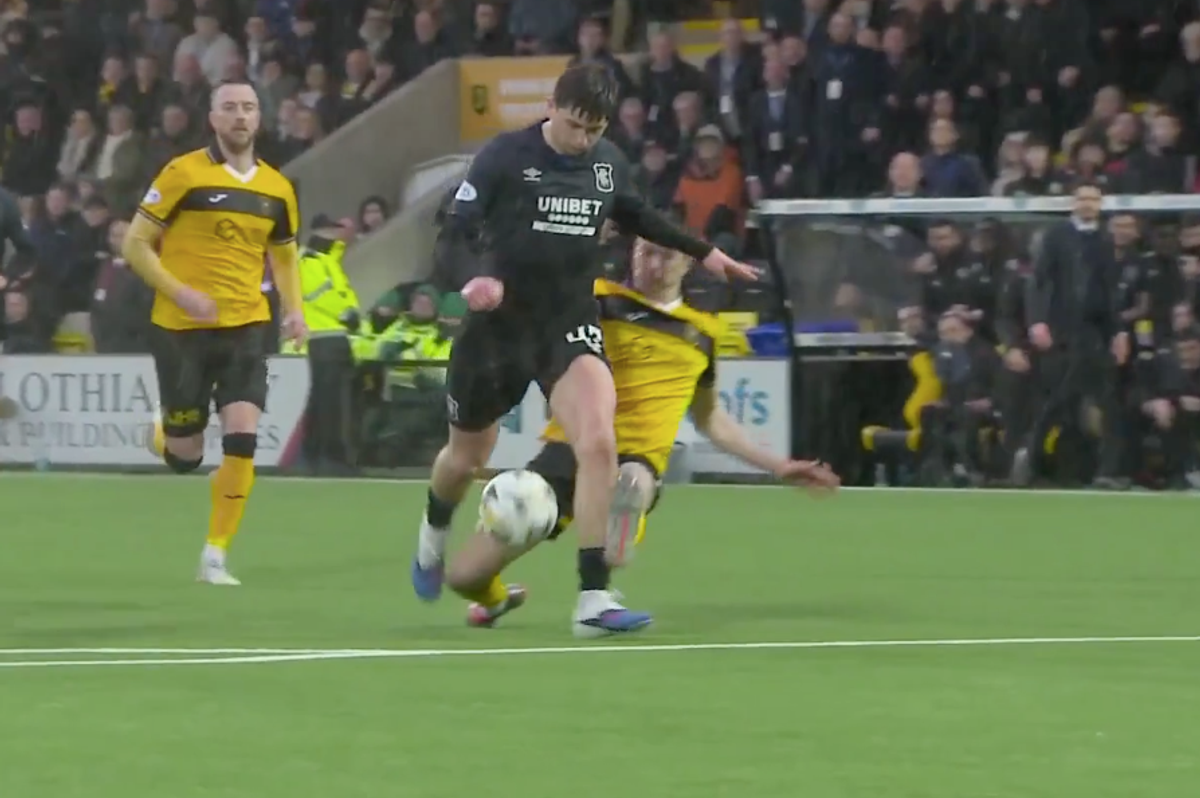 Rangers star Mikey Moore is tackled by Cammy Kerr of Livingston