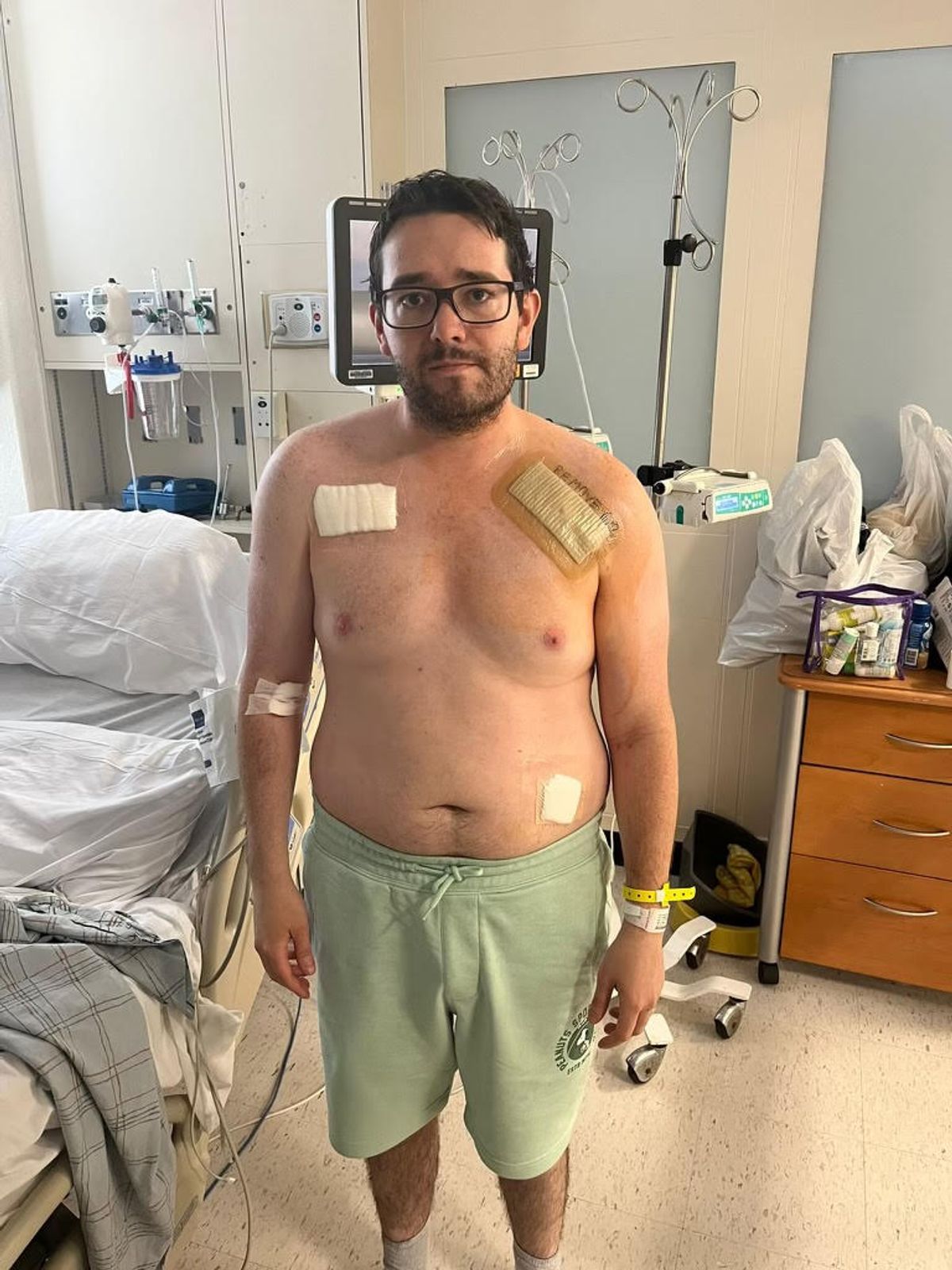 A man standing up in hospital after having a pacemaker fitted