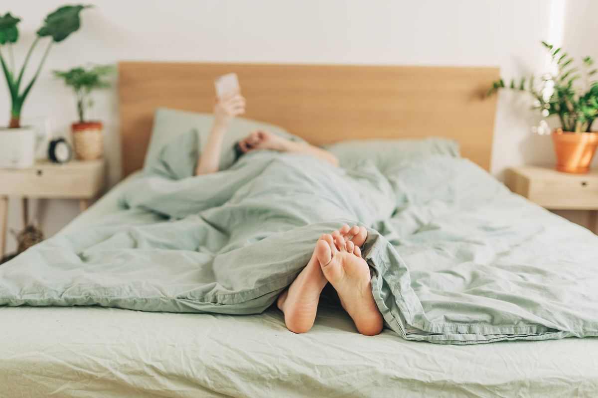 feet sticking out of the covers, generic woman in bed