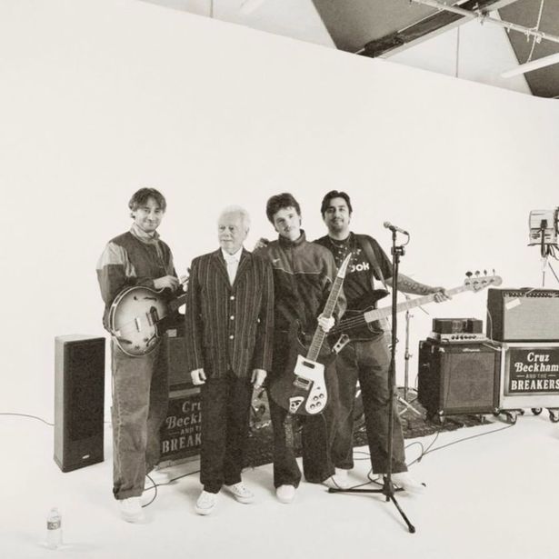Tony posing with Cruz and his The Breakers bandmates