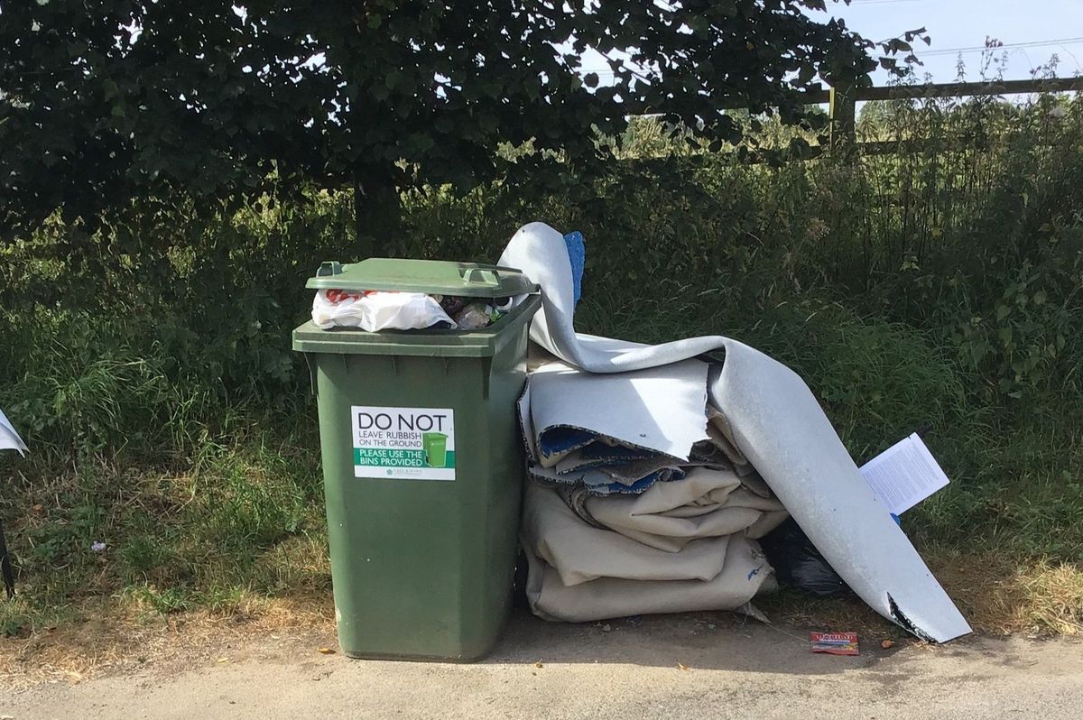 Carpet and rubbish bags were dumped next to a waste bin in a layby on the A1079 Hull to York road, near Walkington
