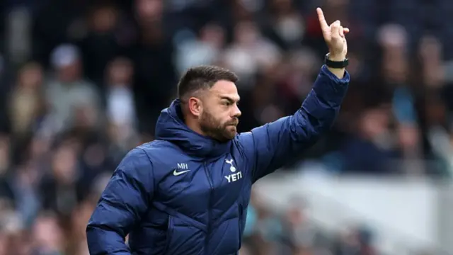 Martin Ho, Manager of Tottenham Hotspur, gestures to his players