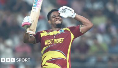 Shimron Hetmyer celebrates reaching a fifty by saluting with his left arm, and holding the blade of his bat with his right hand