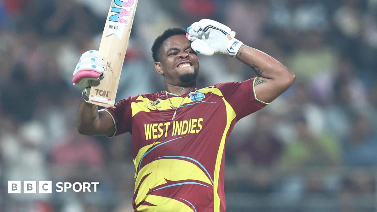 Shimron Hetmyer celebrates reaching a fifty by saluting with his left arm, and holding the blade of his bat with his right hand