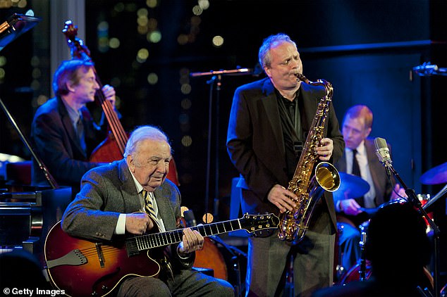 Peplowski is pictured on the saxophone at Dizzy's Club Coca-Cola in 2005, with Bucky Pizzarelli on guitar, Greg Cohen on upright acoustic bass and Chuck Redd on drums