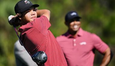 Charlie Woods, with his dad Tiger watching on, plays a shot during the PNC Championship