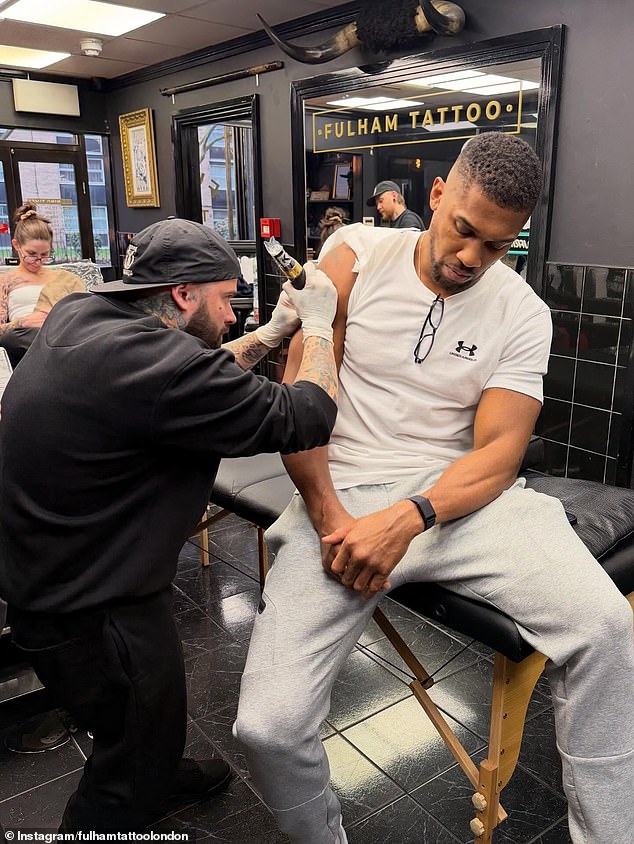 Joshua visited Fulham Tattoo to add his friends' names under the map of Africa on his arm