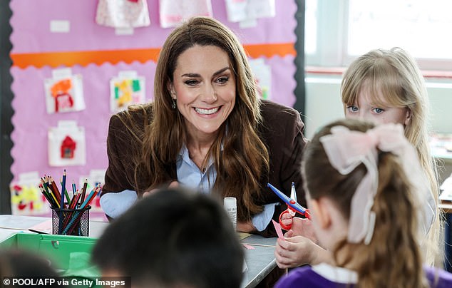 The royal was all smiles as she coloured in and cut up carboard and tissue paper with the children