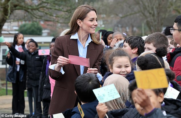 Kate smiled as she received cards from the pupils