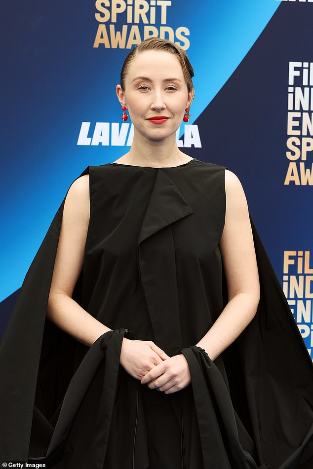 The actress added a touch of color to the look with red earrings and red lipstick