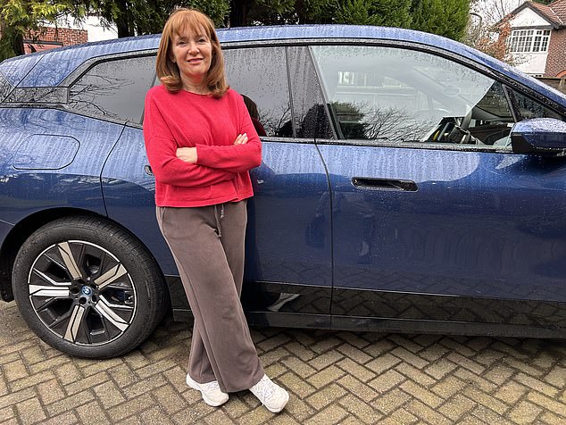 Angela Epstein with her husband’s electric BMW iX40, which makes her feel ill