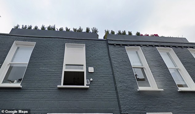 This is how the front of the house currently looks, with the planters that must now be torn down