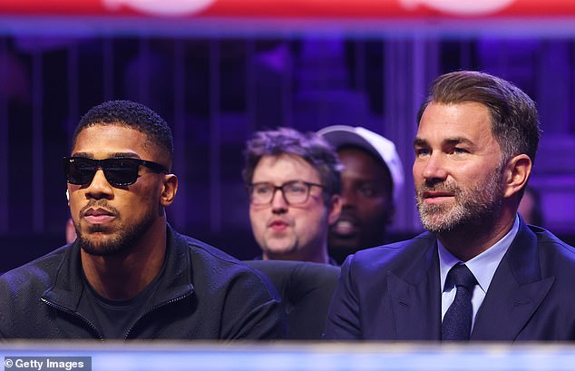 Eddie Hearn (right) has said that Anthony Joshua (left) could return to boxing in the summer