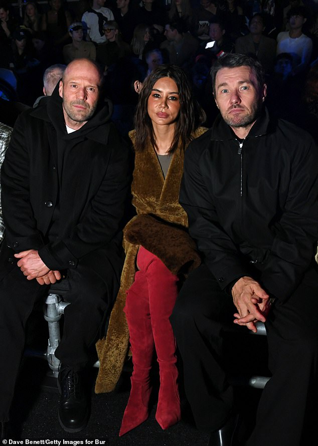 Enjoying the front row seats, from where he could easily spot his stunning fiancé, Jason posed with fellow stars Christine Centenera and Joel Edgerton (R)