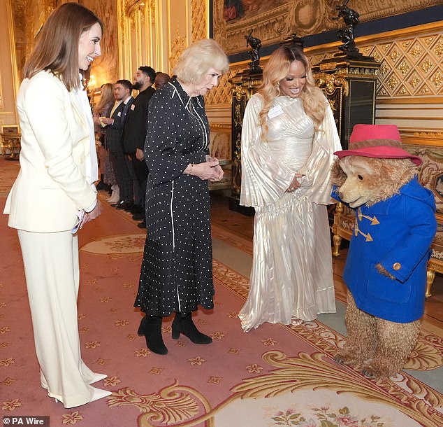 The Welsh broadcaster watches as Paddington Bear salutes Camilla