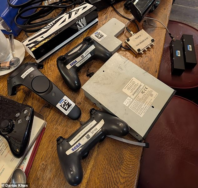 Consoles and controllers bought by Darius Khan in the clearout. The Nintendo console (right) bears a sticker reading 'not for resale' - but he disputes its legality