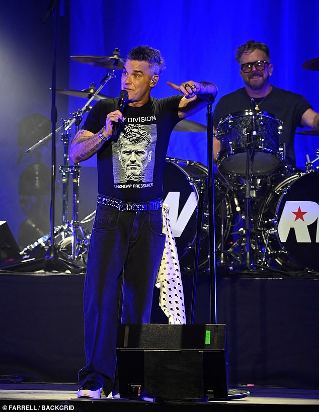 Across town, Robbie Williams took to the stage at Aviva Studios for a special War Child gig, giving fans an early taste of BRITs-week energy (Pictured)