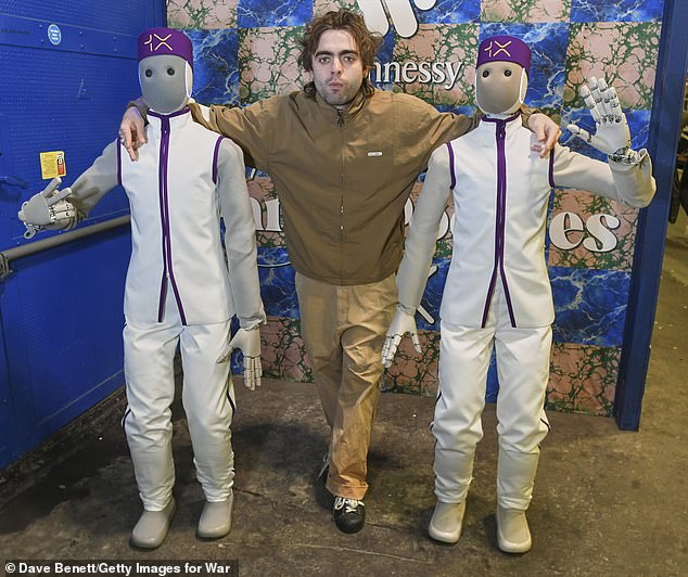 Lennon posed for snaps as 1X's Neo Home robots greeted guests while boarding the star-studded Warner and Hennessy train