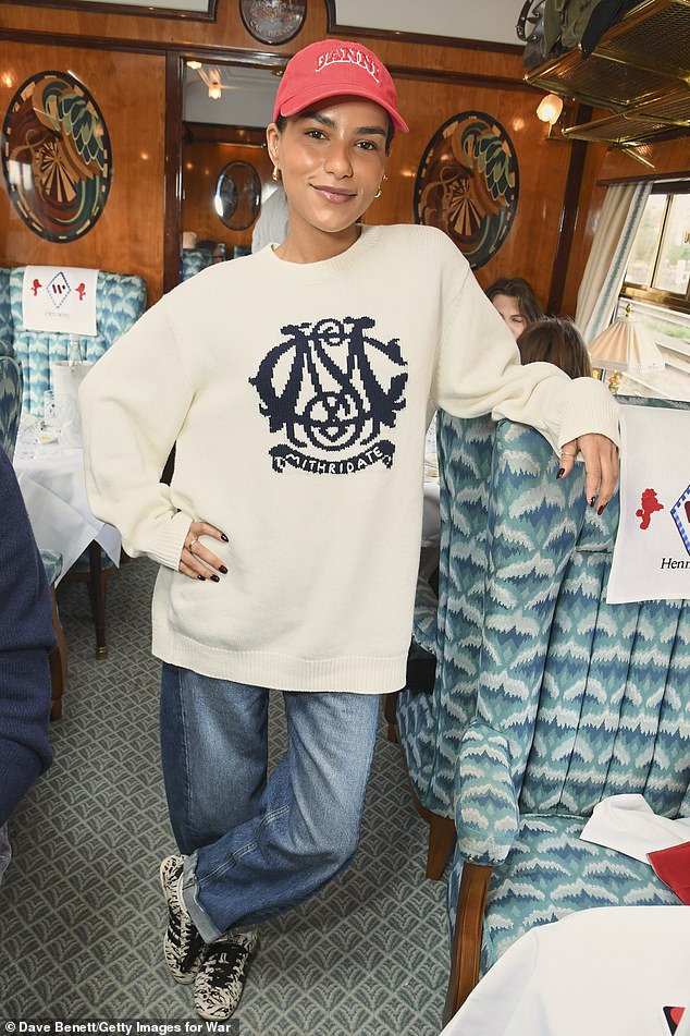 Elsewhere Top Boy star Saffron Hocking posed for snaps in a cream and navy knitted Mithridate sweater, as well as rolled-up jeans, patterned trainers and a red cap