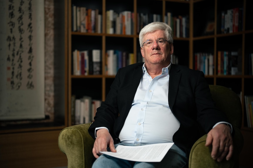 Saul Eslake sits in a chair.