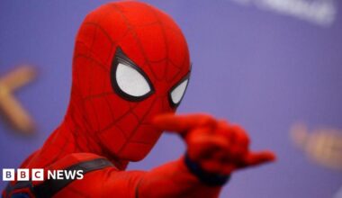 A man dressed as Marvel comics hero Spider-Man poses for photos at a press event