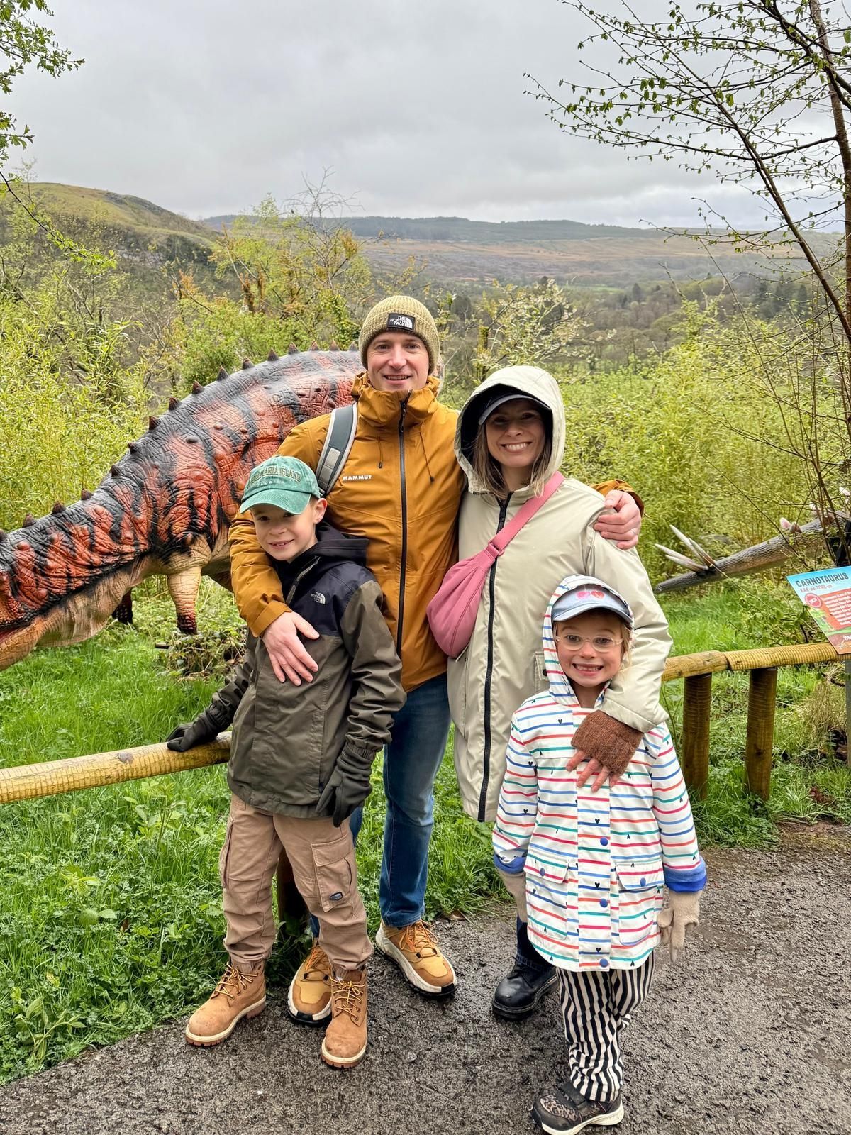 A smiling family of 4 on a walk