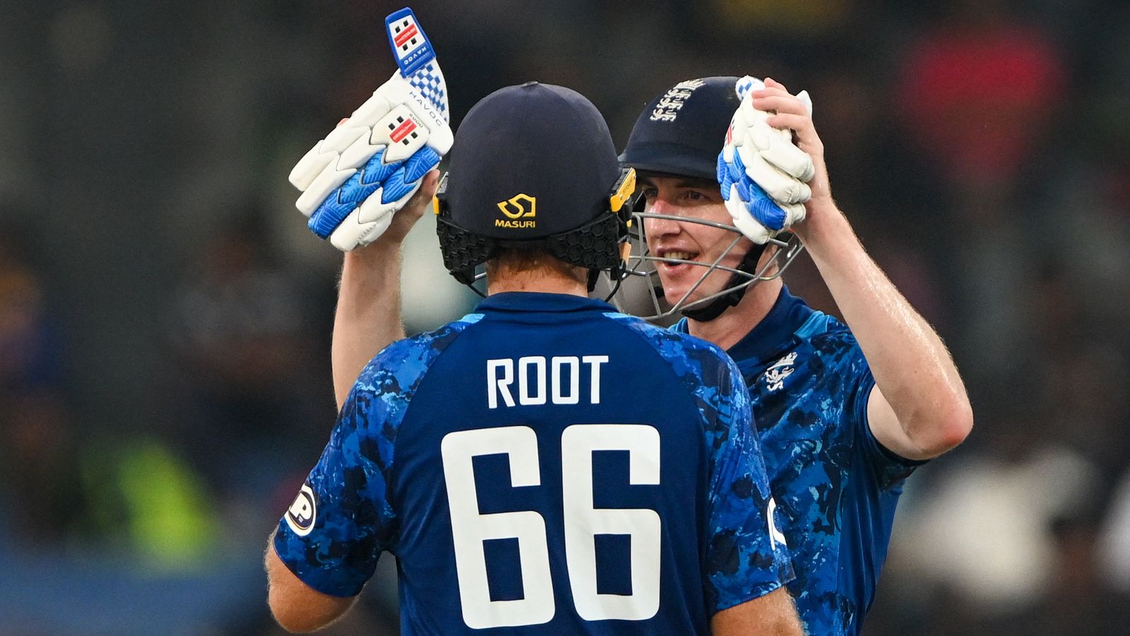 England's captain Harry Brook celebrates after scoring a century (100 runs) with Joe Root during the third one-day international (ODI) cricket match between Sri Lanka and England at the R. Premadasa International Cricket Stadium in Colombo on January 27, 2026. (Photo by Ishara S. KODIKARA / AFP)