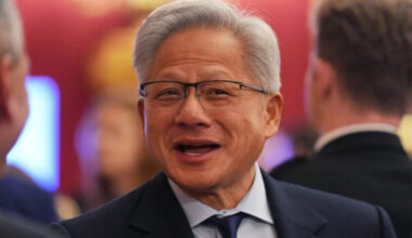 Nvidia CEO Jensen Huang speaking at a tech conference, emphasizing AI advancements and industry innovation.