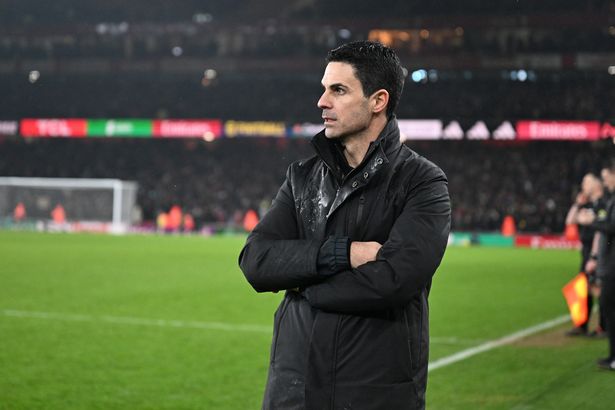 Mikel Arteta looks on.