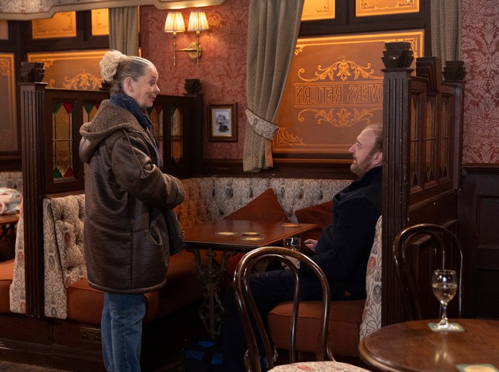 Bernie stands over Mal at the pub in a scene from Coronation Street