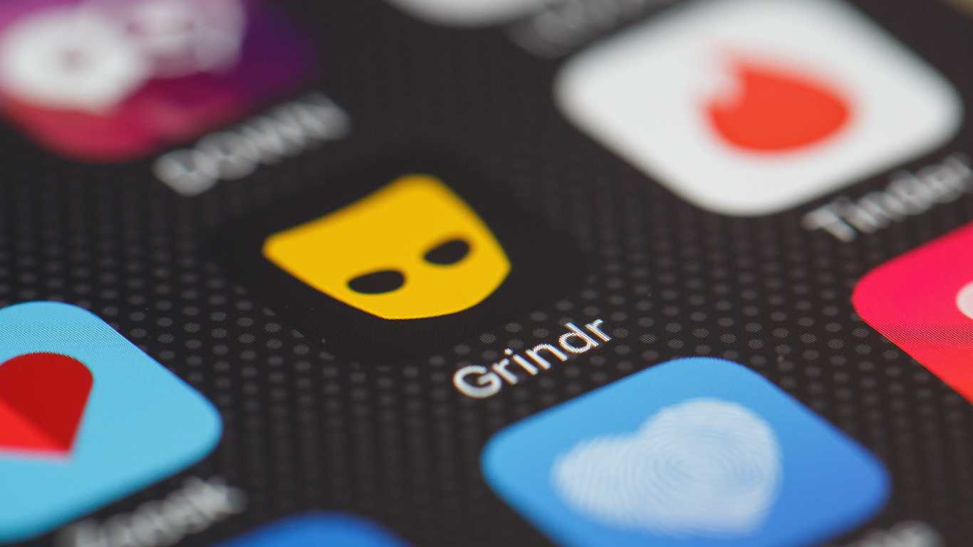 The "Grindr" app logo is seen amongst other dating apps on a mobile phone screen.