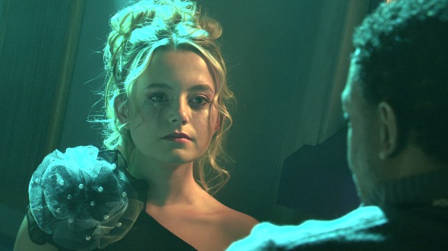 Betsy Swain looking worried under green lights in the police station in Coronation Street.