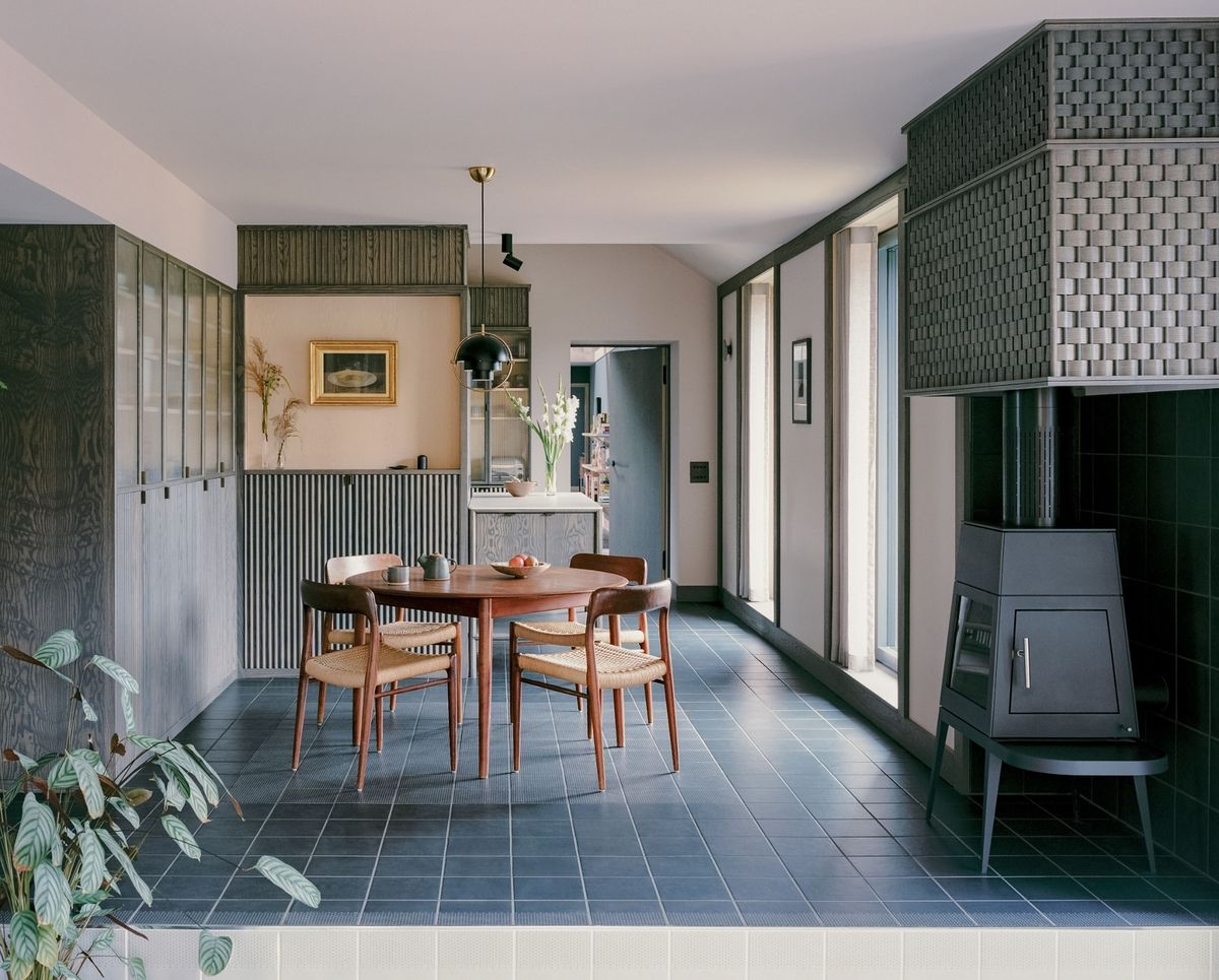 Dining room with grey tiled floor and textured grey walls inside Pantybara by Rural Office one of Six projects shortlisted for RSAW Welsh Architecture Awards 2026 