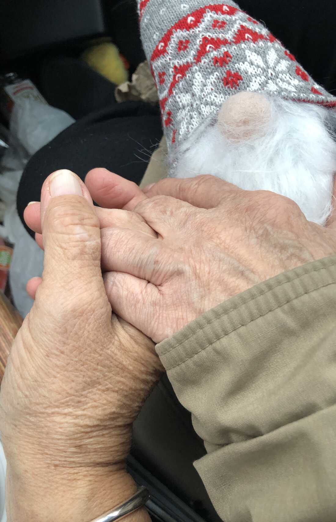 Valerie Staats and Shelley Schultz hold hands.