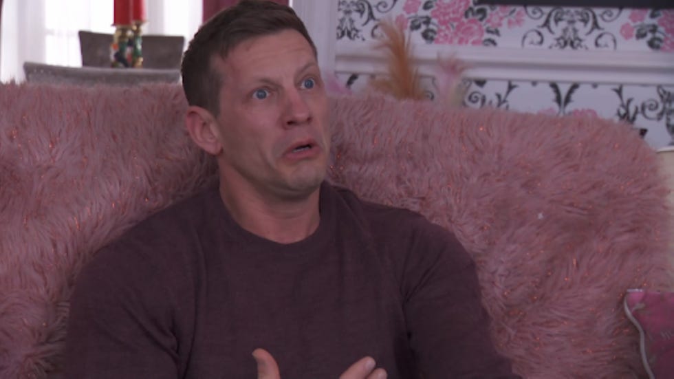 hollyoaks john paul mcqueen individual seated in a cozy setting engaged in conversation