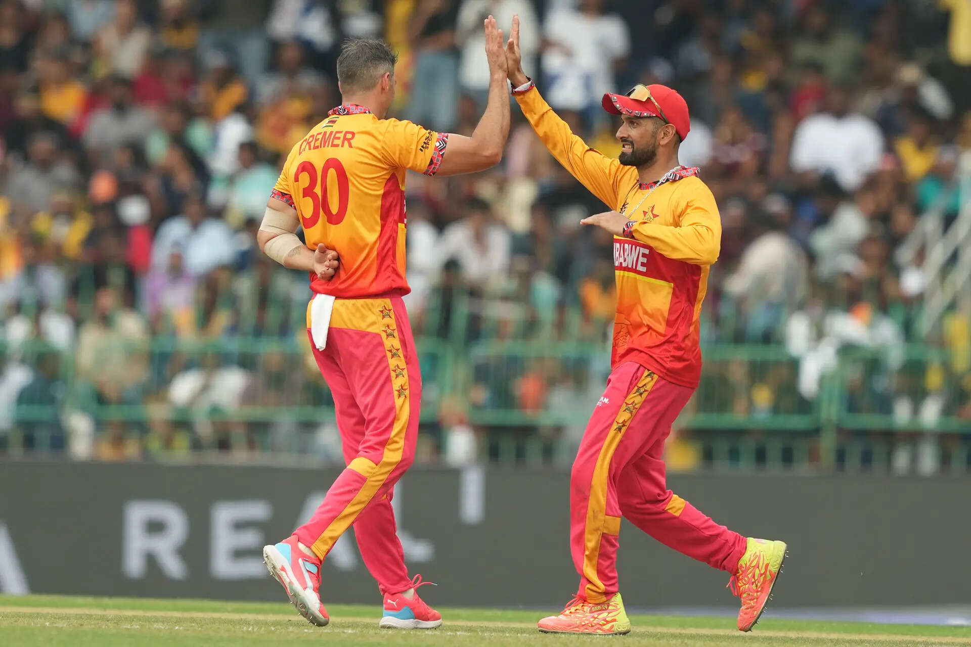 Zimbabwe's Graeme Cremer, left, celebrates with captain Sikandar Raza the wicket of Sri Lanka's Kamindu Mendis during the T20 World Cup cricket match between Sri Lanka and Zimbabwe in Colombo, Sri Lanka, Thursday, Feb. 19, 2026. (AP Photo/Eranga Jayawardena) Sri Lanka Zimbabwe T20 WCup Cricket